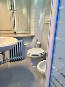 a bathroom with a toilet and a sink at Residenza del Duca in Senigallia +12 photos