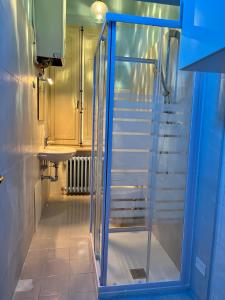 a glass shower in a bathroom with stairs at Residenza del Duca in Senigallia