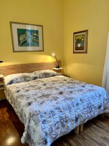 a bedroom with a bed with a blue comforter at Residenza del Duca in Senigallia