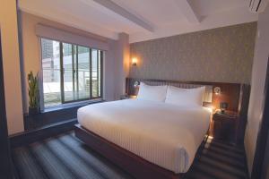 a bedroom with a large bed and a window at Hotel Edison Times Square in New York
