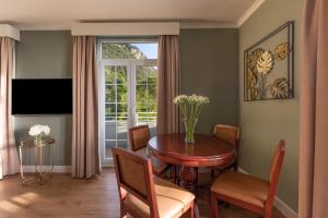 a living room with a table and a window at Rock Hotel in Gibraltar