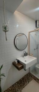 La salle de bains est pourvue d'un lavabo blanc et d'un miroir. dans l'établissement Lax Uno 2 bedroom home with Parking, Wi-Fi, NetFlix and Airconditioned Rooms and Shower Heater, à Antipolo