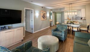 a living room with a kitchen and a dining room at Star Island Resort and Club - Near Disney in Kissimmee