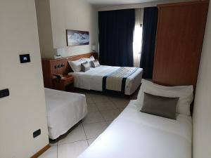 Postel nebo postele na pokoji v ubytování Green Hotel Ninfa