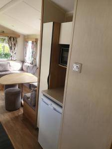 a small kitchen and living room in a caravan at Fantasy Island King Fisher 8Berth 401 in Ingoldmells