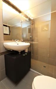a bathroom with a sink and a toilet at Cozy 2 Bedroom apt @Panormou Metro/Erytros Stavros in Athens