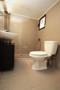 a bathroom with a toilet and a sink at Cozy 2 Bedroom apt @Panormou Metro/Erytros Stavros in Athens