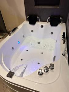 a white bath tub sitting in a bathroom at Casa Indigo Laureles-Estadio con Jacuzzi in Medellín