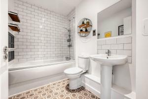 a white bathroom with a toilet and a sink at The Post House Two in Gloucester