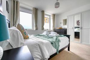 a bedroom with a bed and two windows at The Post House Two in Gloucester