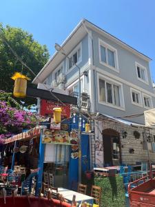 a building with tables and chairs in front of a restaurant at Ada Antik 2 in Adalar