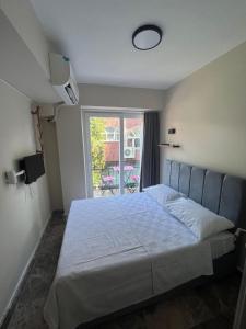 a bedroom with a large bed with a window at Ada Antik 2 in Adalar