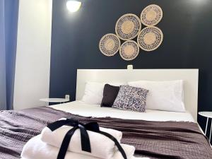 a bedroom with a bed with plates on the wall at Apartments Ana & Ita in Novalja