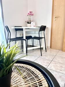 a table and chairs in a room with a table at Apartments Ana & Ita in Novalja