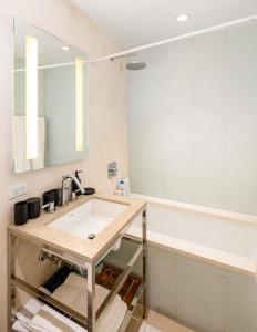 a bathroom with a sink and a mirror at Gorgeous One-Bedroom on 35th floor in Midtown in New York