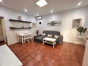 a living room with a couch and a table at Chalet Empul El Béjar in Chiclana de la Frontera