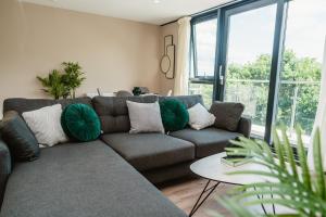 a living room with a couch and a large window at VICHY - The Glass House VIP Luxury Stay with gym, Cinema & Gaming Rooms, and Work space access in Hull