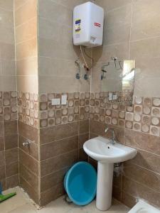 a bathroom with a sink and a toilet at استوديو للعائلات داخل قرية Retal View north coast in El Alamein