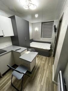 リヴィウにあるФілатова 18のベッドとデスクが備わる小さな客室です。