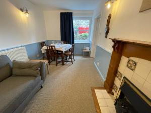 a living room with a couch and a table at Glanywerydd Cottage in Barmouth
