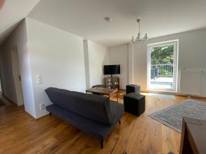 a living room with a couch and a window at Little Paradise in the Center of Baden near Vienna in Baden