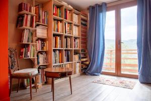 a room with book shelves filled with books at Mas la Marchette in Oms
