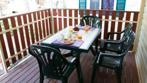 a table on a balcony with a meal on it at Camping Badiaccia Village in Castiglione del Lago