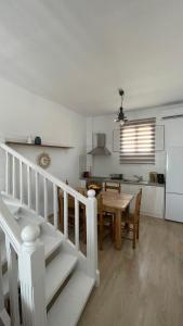 a kitchen and dining room with a table and a dining room gmaxwell gmaxwell at Anthoula Home Paros in Naousa +20 photos
