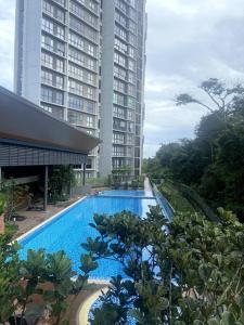 a swimming pool in front of two tall buildings at Modern Apartment in WP Putrajaya in Putrajaya