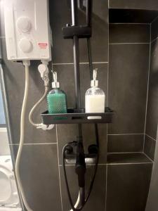 a bathroom with a soap dispenser on a wall at Modern Apartment in WP Putrajaya in Putrajaya