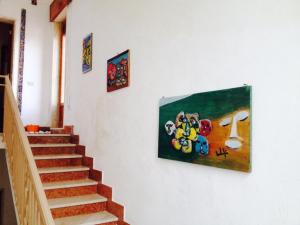 a painting hanging on a wall next to a staircase at La Terrazza Sul Mar Mediterraneo in Marinella di Selinunte