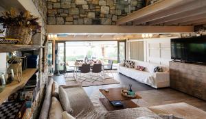 a living room with a couch and a tv at Hacienda Verde in Serres