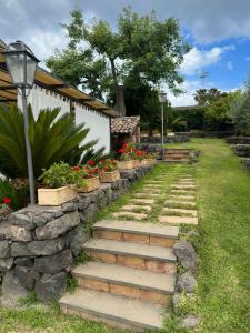 een stenen pad met een stenen muur en wat bloemen bij Villa del Sole in Valverde
