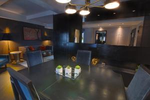 a dining room with a table with plants on it at Hotel Edison Times Square in New York