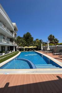 a swimming pool in front of a building at As Hotel Cesme in Çeşme