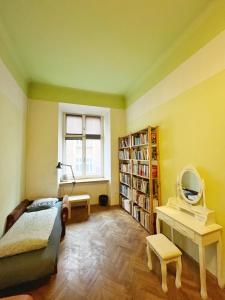 a bedroom with a bed and a mirror and bookshelves at Old Town Rooms Wielopole in Krakow