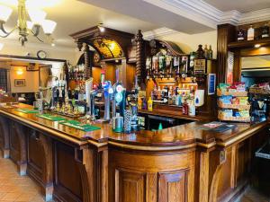 a bar in a pub with a lot of alcohol at The Oaks Hotel in Alnwick