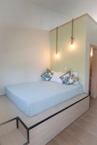 a bed in a bedroom with two pillows on it at Topos Maisonettes by RentalsPro - Kalives Halkidiki in Kalivia Poligirou