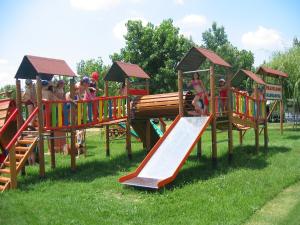 a group of children playing on a playground at Camping Badiaccia Village in Castiglione del Lago