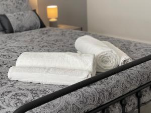 two towels sitting on top of a bed at Belford Apartment, Close to Tynemouth in Tynemouth