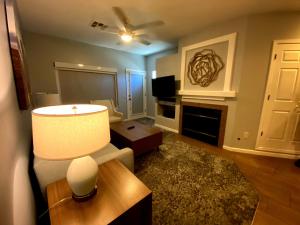 a living room with a couch and a table with a lamp at WorldMark Rancho Vistoso in Oro Valley
