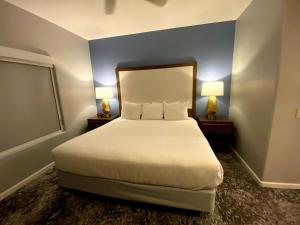 a bedroom with a large bed with two lamps at WorldMark Rancho Vistoso in Oro Valley