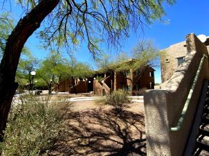 a fence in front of a building with a tree at WorldMark Rancho Vistoso in Oro Valley +68 photos