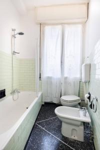 a bathroom with a toilet and a tub and a sink at We Home - SANLUCA57, Bologna in Bologna
