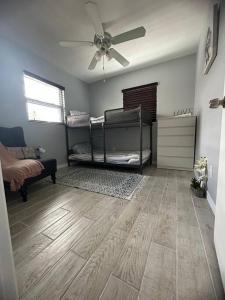 a room with two bunk beds and a ceiling fan at Minutes away from Clearwater beach in Clearwater