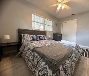 a bedroom with a bed and a ceiling fan at Minutes away from Clearwater beach in Clearwater