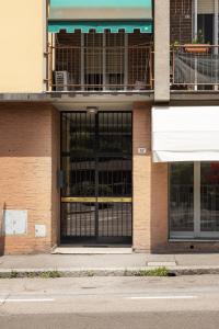 a store front with a black gate on a building at We Home - SANLUCA57, Bologna in Bologna