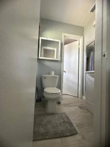 a white bathroom with a toilet and a sink at Minutes away from Clearwater beach in Clearwater