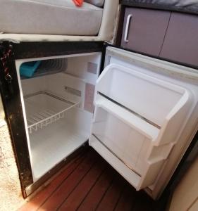 an empty refrigerator with its door open in a room at Dormir sur un yacht insolite in La Rochelle