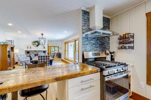 a kitchen with a stove and a dining room at Shore Acres in Isle la Motte